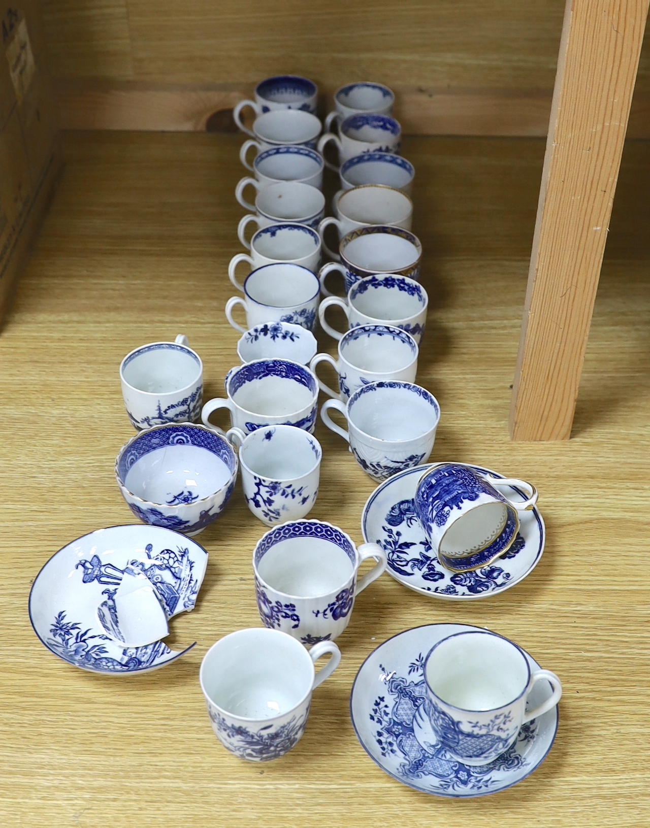 A collection of late 18th century Worcester, Caughley etc. blue and white coffee cups and saucers, the largest 12cm in diameter